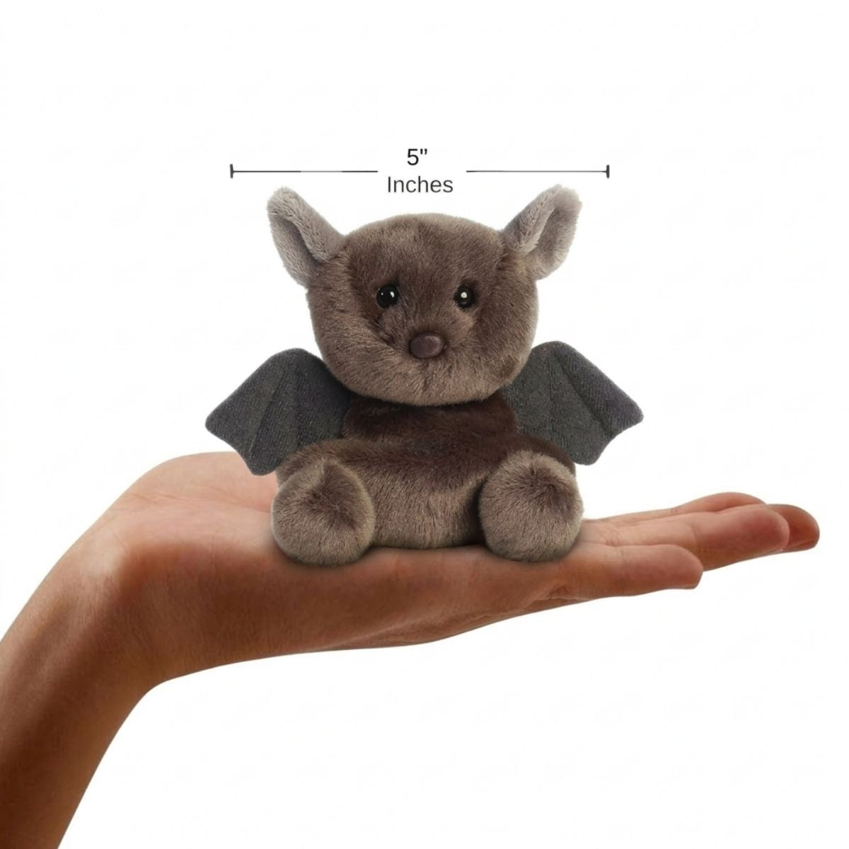 The miniature Luna Bat plush sitting balanced in an open human hand under a 5-inch height graphic indicator.