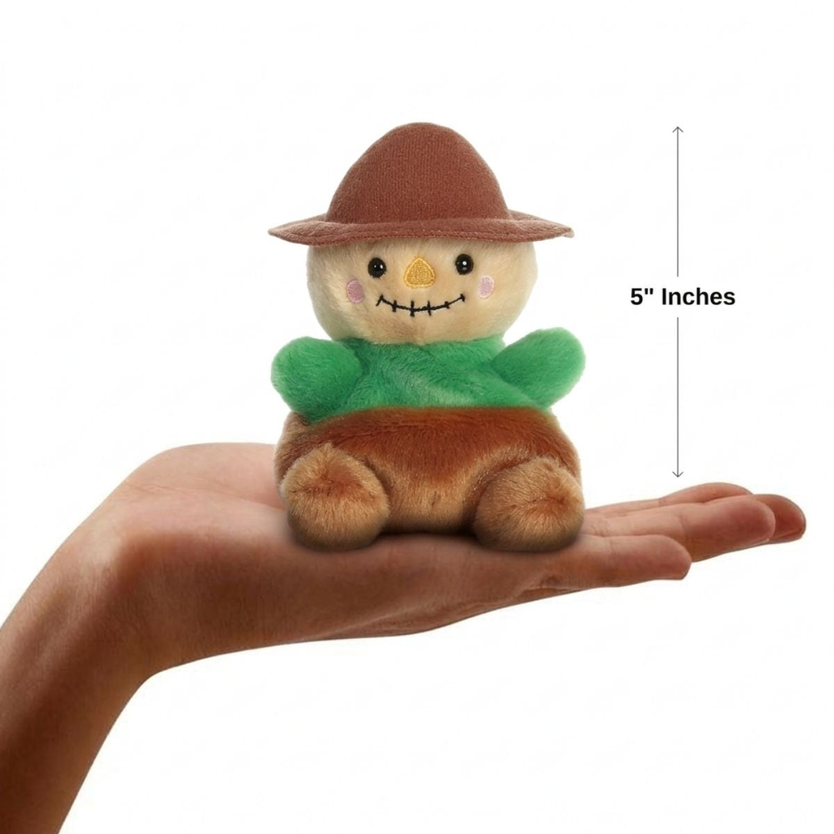 The miniature Cornelius Scarecrow plush sitting balanced in an open human hand under a 5-inch height graphic indicator.