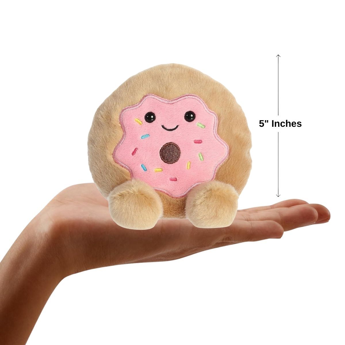 Dimension graphic showing the 5-inch Aurora Palm Pals Claire Donut resting comfortably in a person's hand.