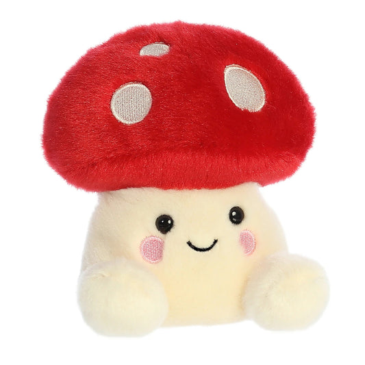 Plush toy with a red mushroom cap and smiling face on a white background