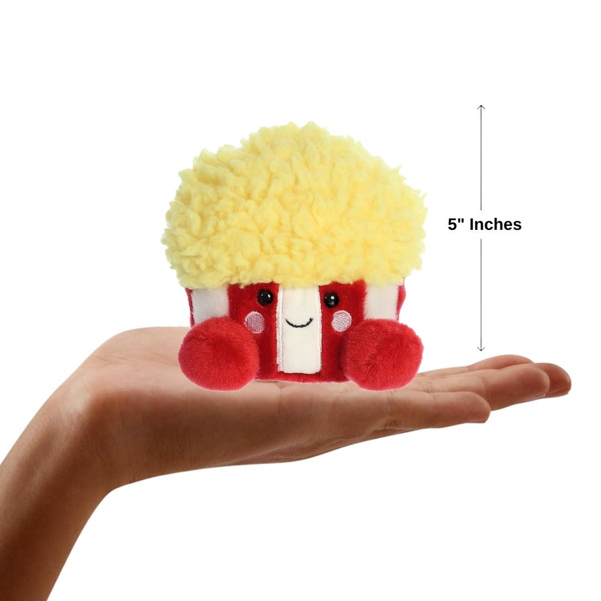 Sizing graphic for the Aurora Palm Pals Butters Popcorn plush showing it sitting perfectly in the palm of a hand, indicating a total height of 5 inches.