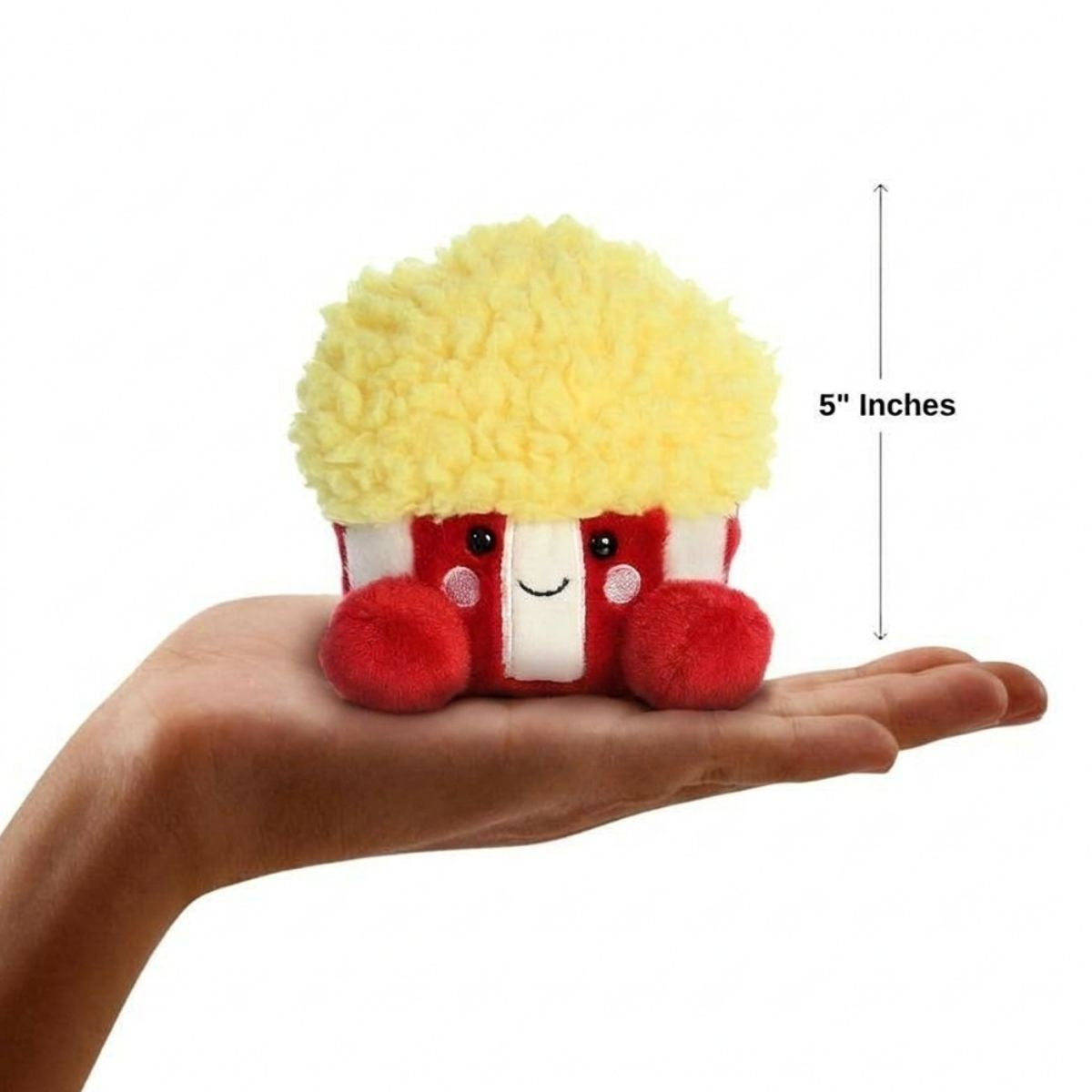 Sizing graphic for the Aurora Palm Pals Butters Popcorn plush showing it sitting perfectly in the palm of a hand, indicating a total height of 5 inches.