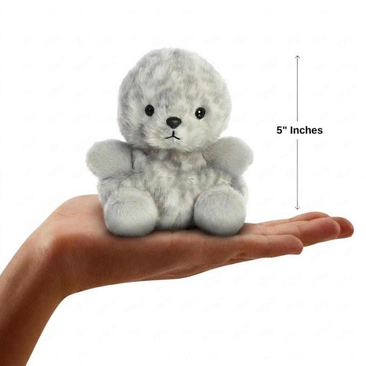Sizing graphic for the Aurora Palm Pals Marina Harbor Seal plush showing it sitting perfectly in the palm of a hand, indicating a total height of 5 inches.