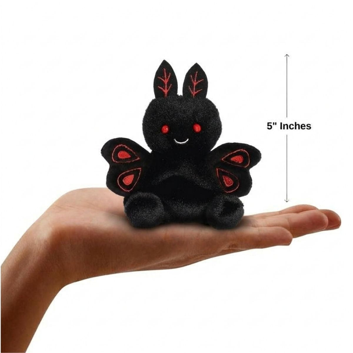 The miniature Mortimer Mothman plush sitting balanced in an open human hand under a 5-inch height graphic indicator.
