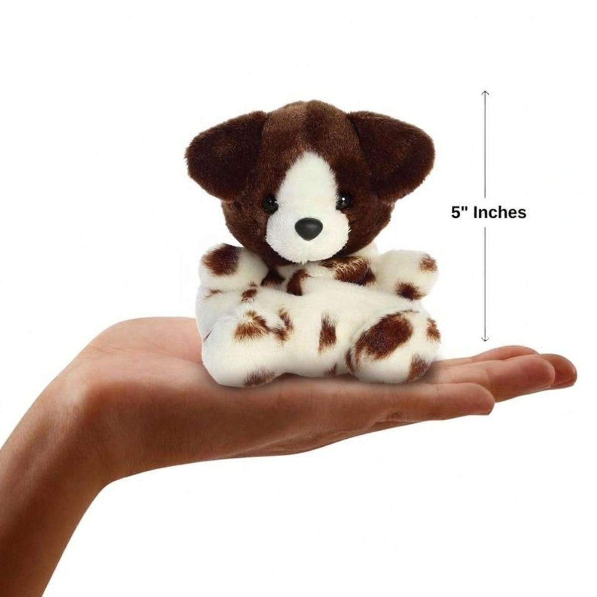 The miniature Freckles dog plush sitting balanced in an open human hand under a 5-inch height graphic indicator.