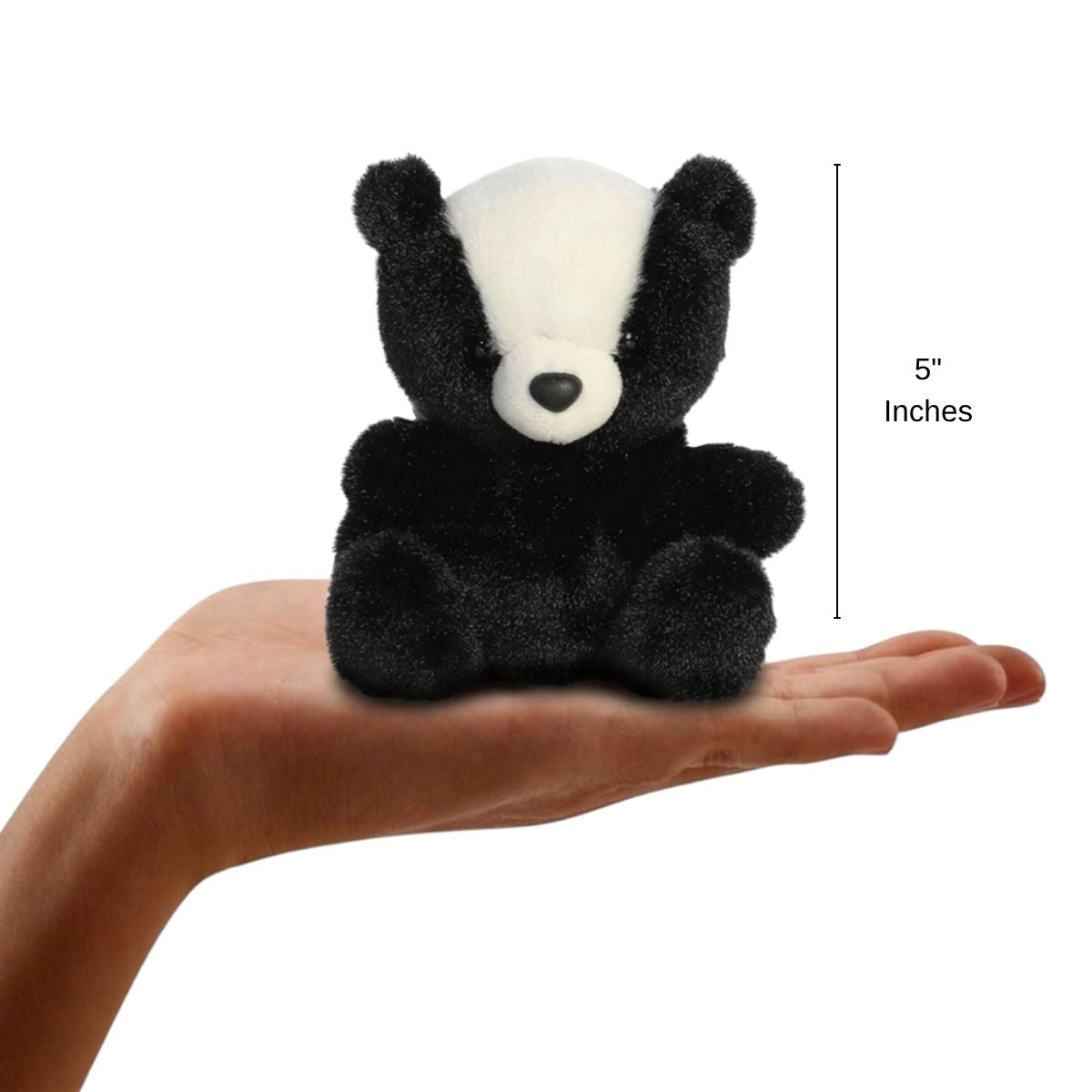 The miniature Scout Skunk plush sitting balanced in an open human hand under a 5-inch height graphic indicator.
