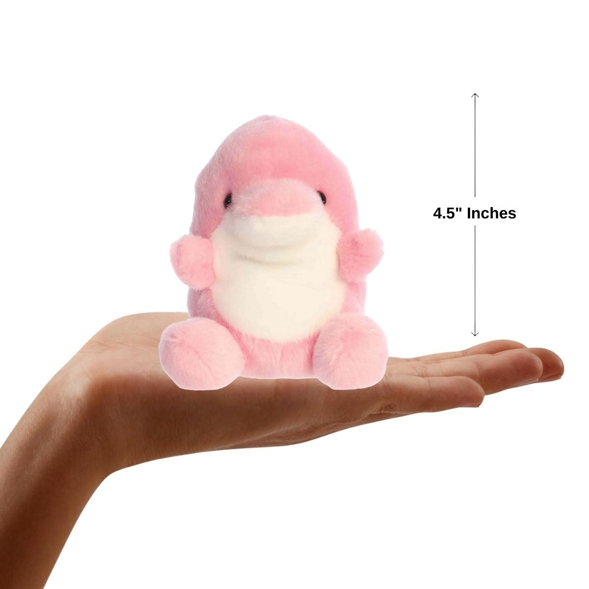 Sizing graphic for the Aurora Palm Pals Amazonia Pink Dolphin plush showing it sitting perfectly in the palm of a hand, indicating a pocket-sized scale.