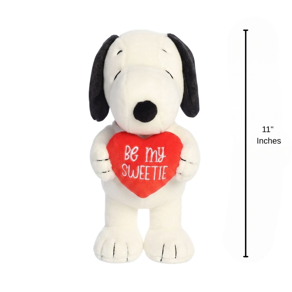 The holiday Snoopy plush standing upright next to an 11-inch vertical height graphic indicator.