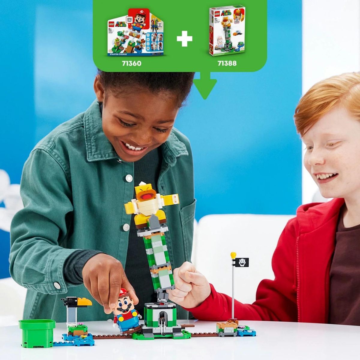 Two kids smiling as they successfully topple the Boss Sumo Bro from the top of the tower during interactive play.