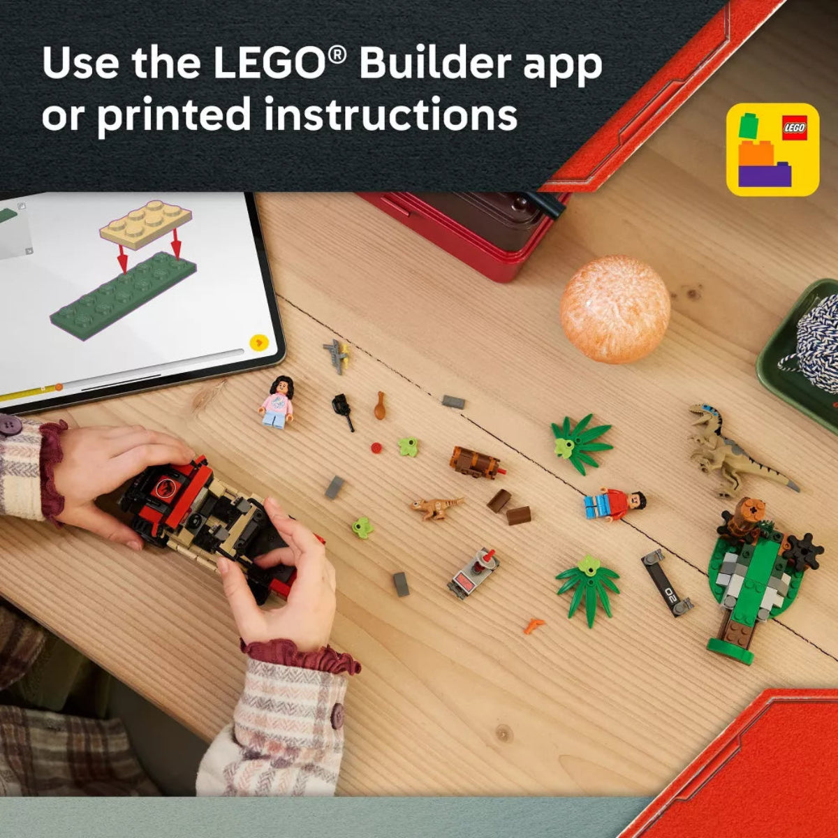 Person building a LEGO set with tablet and printed instructions on a wooden table