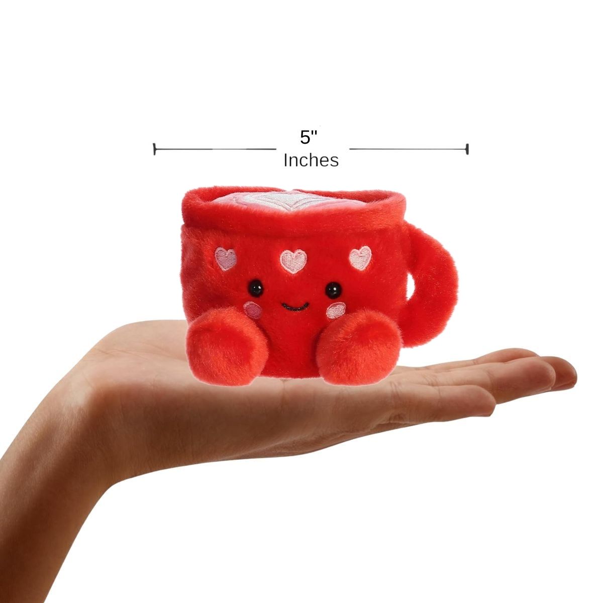 Sizing graphic showing the 5-inch Palm Pals Lotti Love Latte plush sitting perfectly in the palm of a hand to demonstrate its small scale.