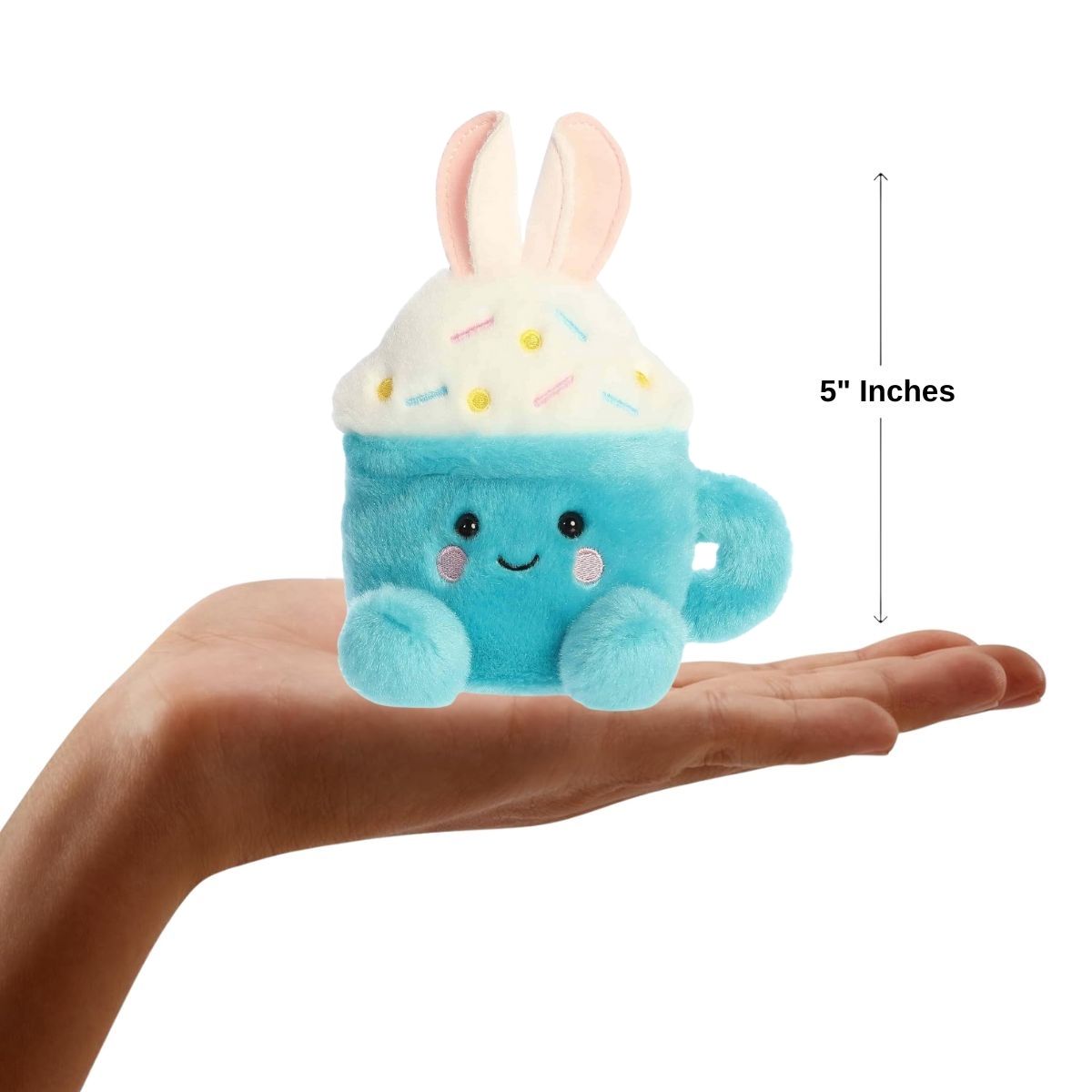 Sizing graphic for the Aurora Palm Pals Lopi Bunny Latte plush showing it sitting perfectly in the palm of a hand, indicating a total height of 5 inches.