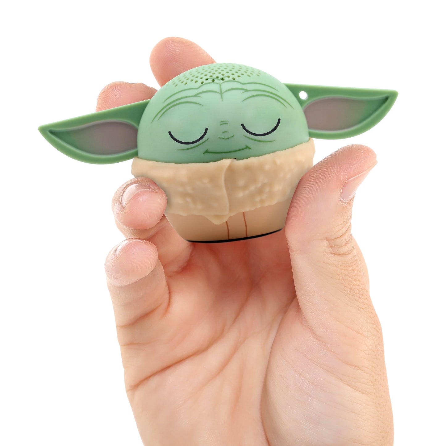 A hand holding the Bitty Boomers Grogu mini Bluetooth speaker, demonstrating its ultra-portable, 2-inch pocket size.