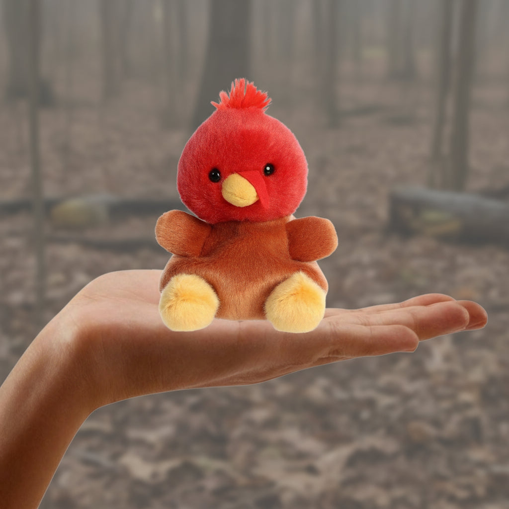 Small red and brown plush toy held in a hand with a measurement label indicating 5 inches.