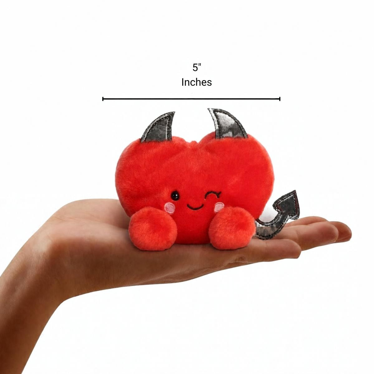 Aurora Palm Pals 5-inch Lilith Devil Heart plush resting in the palm of an open hand.