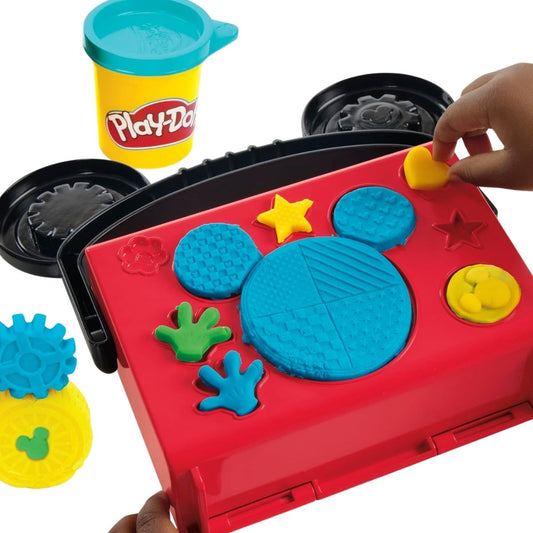 Detail view thumbnail of hands using the built-in Mickey head shape molds on top of the red Play-Doh carrying case.