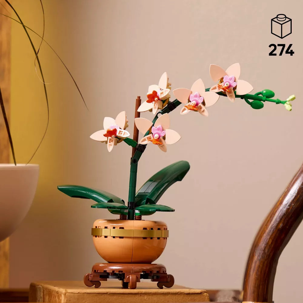 Model of an orchid plant on a wooden base with a beige background
