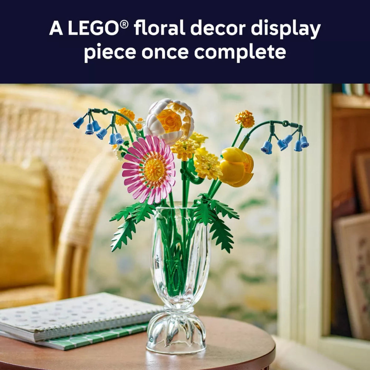 LEGO floral display in a glass vase on a table with a blurred background