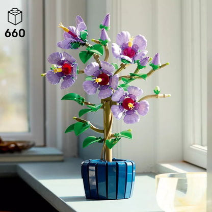 Colorful flower arrangement in a blue vase on a light surface with a blurred background