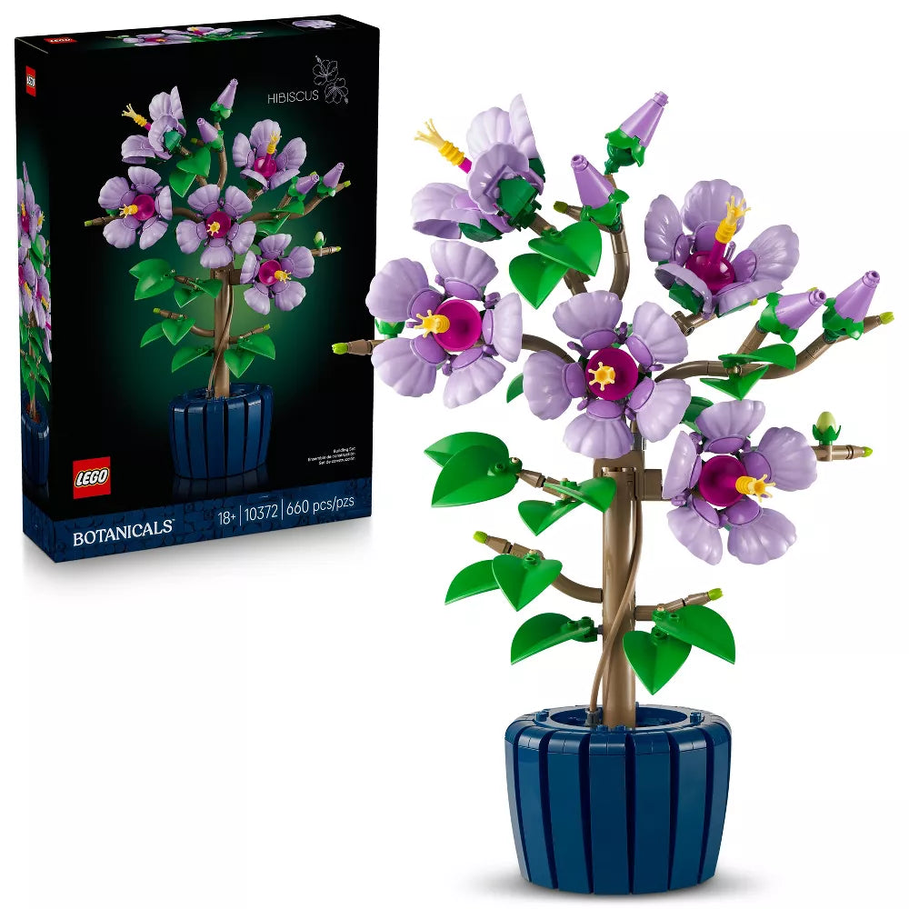 LEGO Botanicals set with purple flowers and green leaves in a blue pot, next to its packaging.