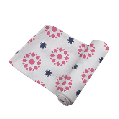 Angled view of the Primrose Indigo swaddle blanket partially unrolled to showcase the pink and blue floral mandala pattern.