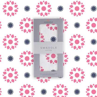 Flat lay of the Newcastle Classics Primrose Indigo cotton muslin swaddle blanket shown with its branded grey packaging box in the center.
