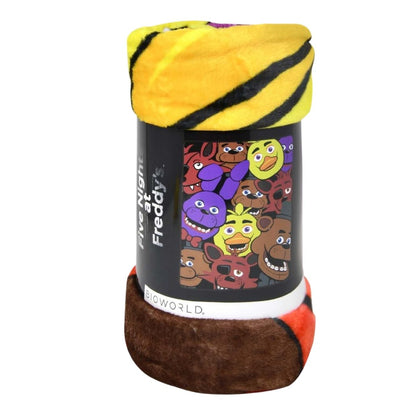 Close-up view of the rolled-up Five Nights at Freddy's fleece throw blanket showing its soft texture and the printed packaging band.