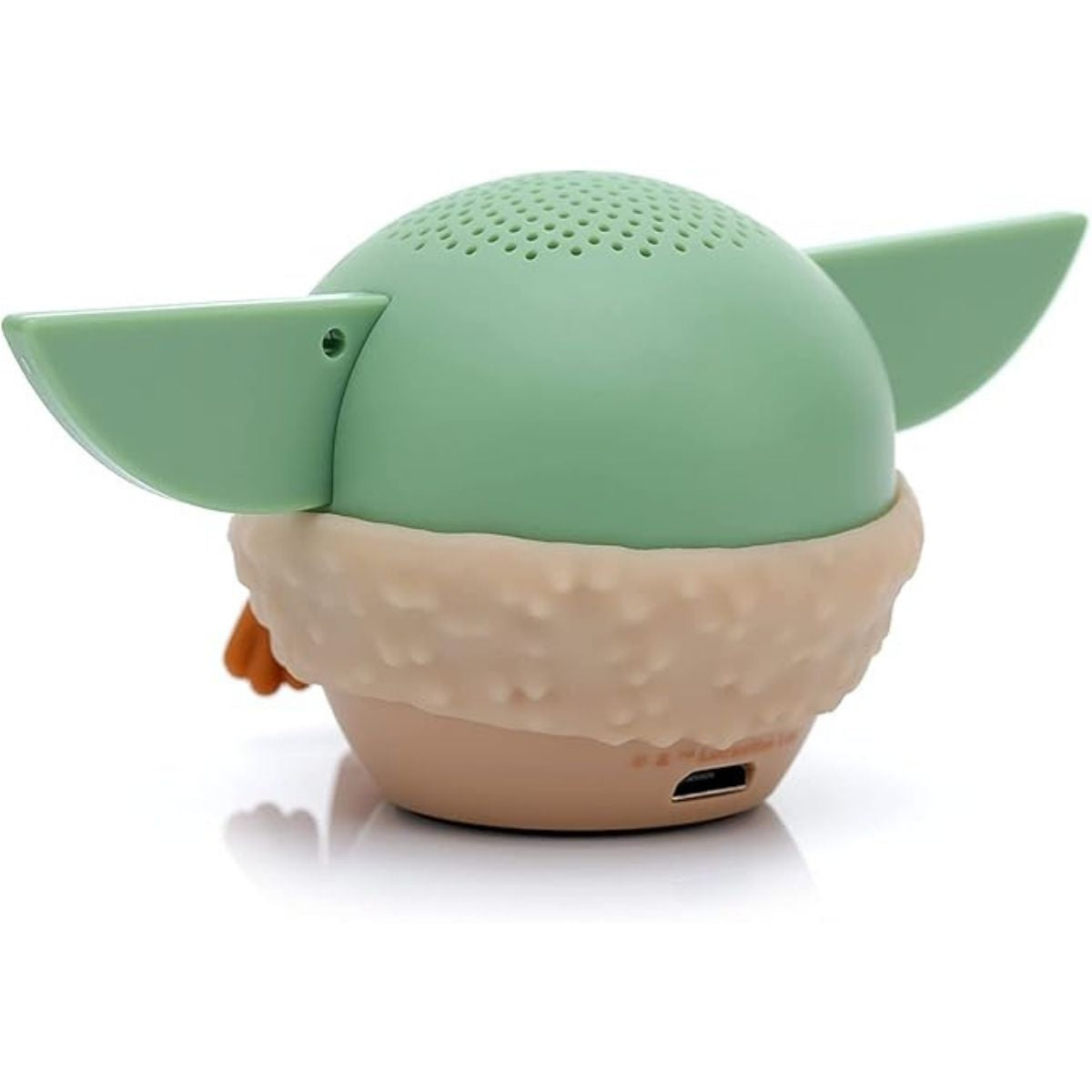 Angled back view of the meditating Grogu mini speaker showing its smooth green back and lower charging port.