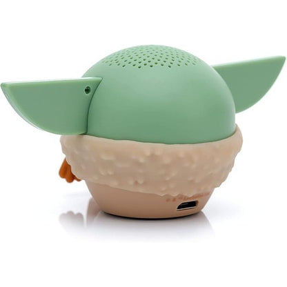 Angled back view of the meditating Grogu mini speaker showing its smooth green back and lower charging port.