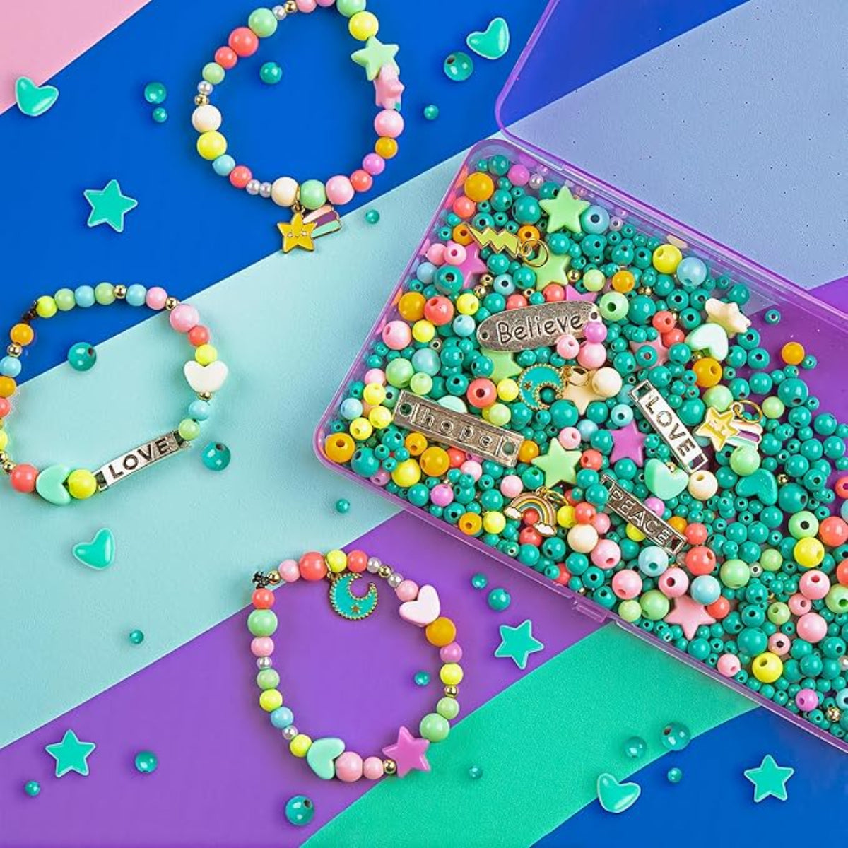 Colorful beaded bracelets and a box of beads on a multicolored background