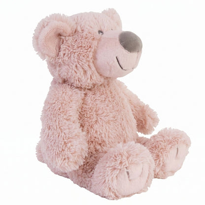 An angled side view of the sitting pink Happy Horse teddy bear highlighting its plump shape and soft weighted base.