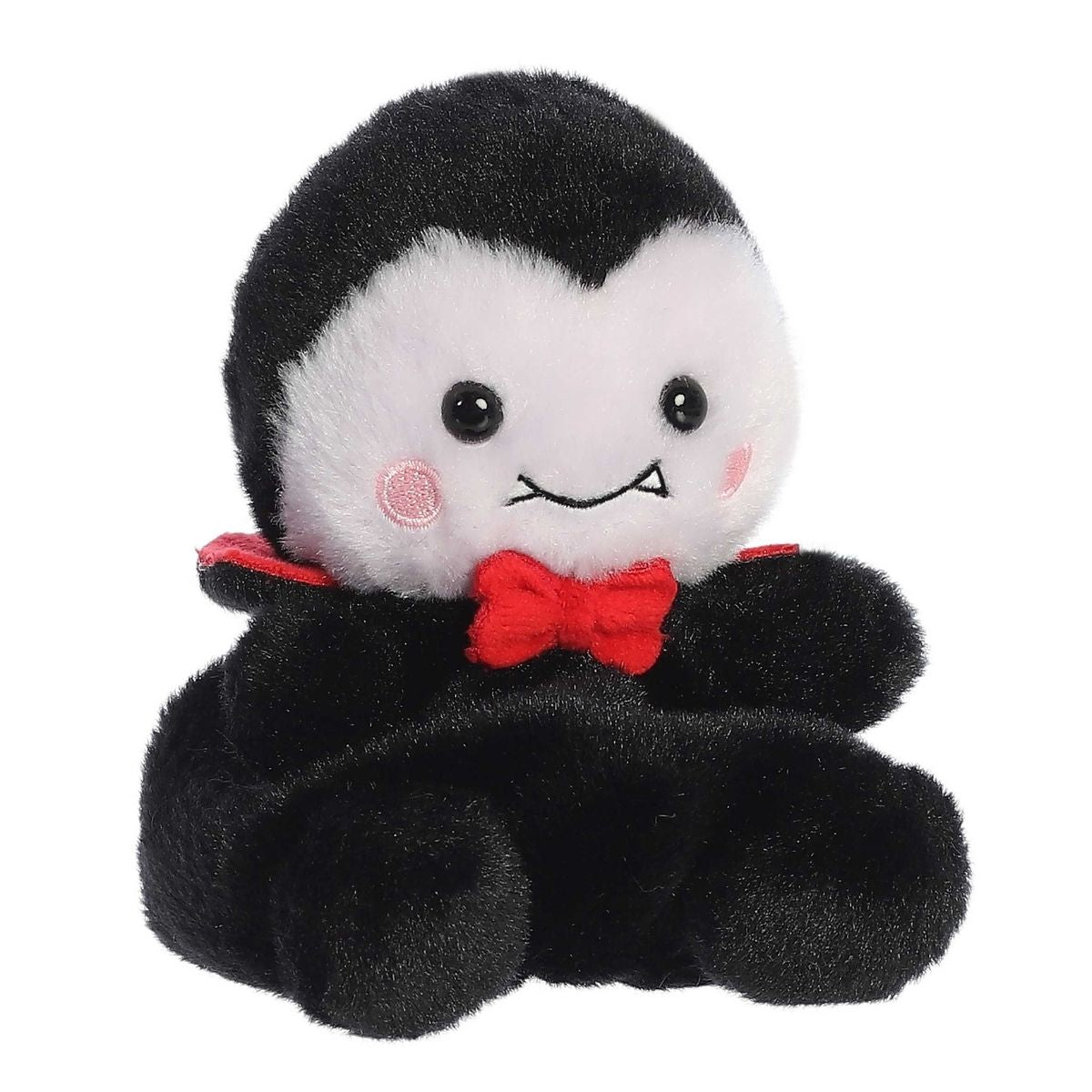 Aurora 5-inch Palm Pals Viktor Vampire plush toy sitting at an angle showing its black cape body, white face with tiny fangs, red bow tie, and red collar.