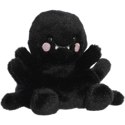 Aurora 5-inch Palm Pals Penny Mae Spider plush toy showing its jet-black fuzzy body, soft legs extending outwards, and cute face with tiny white fangs and pink cheeks.