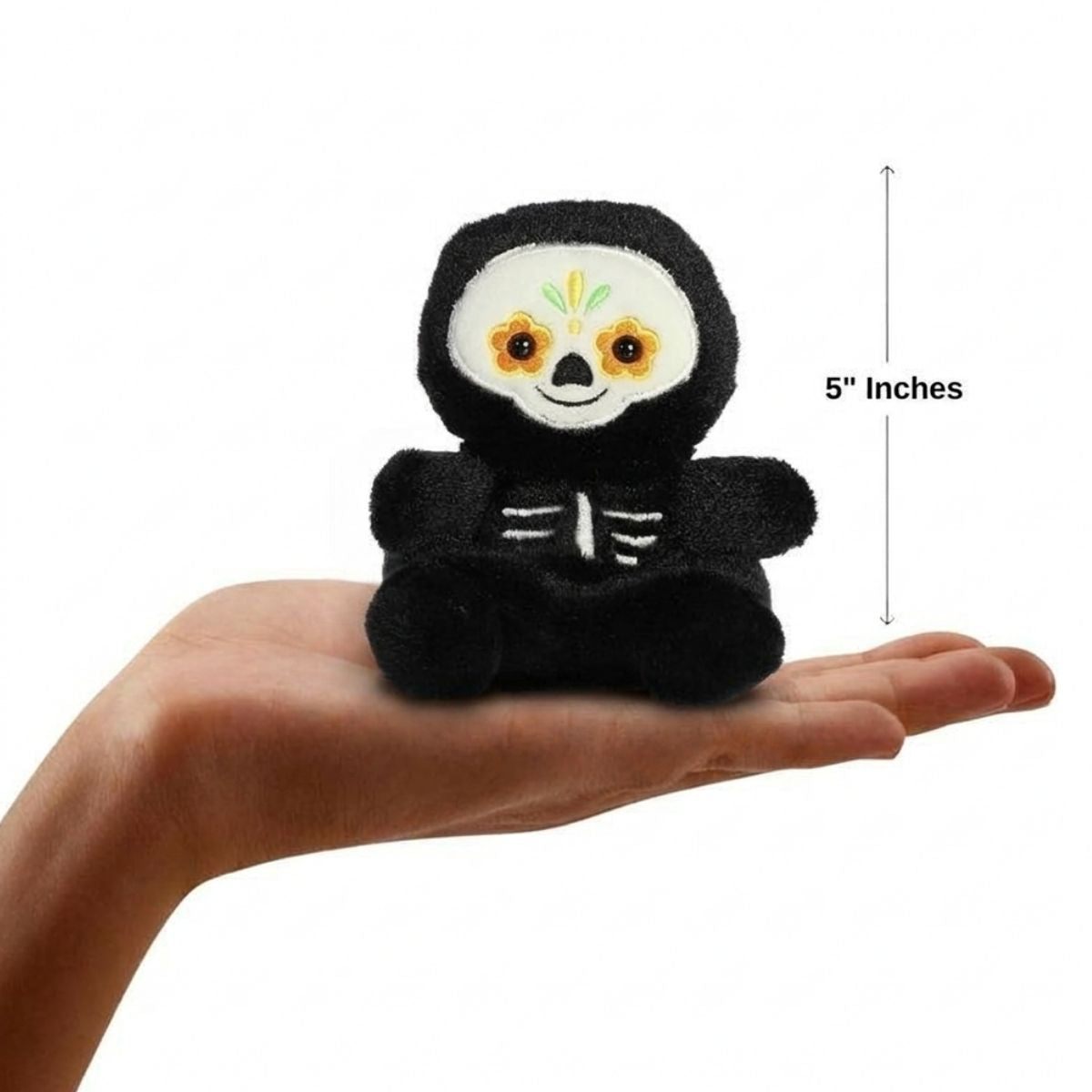 The miniature Santiago Sugar Skull plush sitting balanced in an open human hand under a 5-inch height graphic indicator.