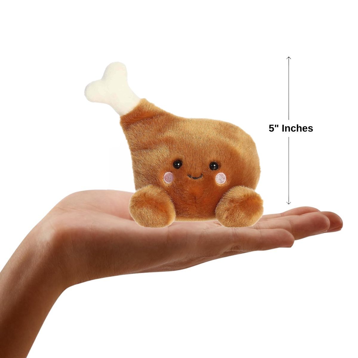 The miniature Mila Drumstick plush sitting balanced in the palm of an open human hand under a 5-inch height graphic indicator.