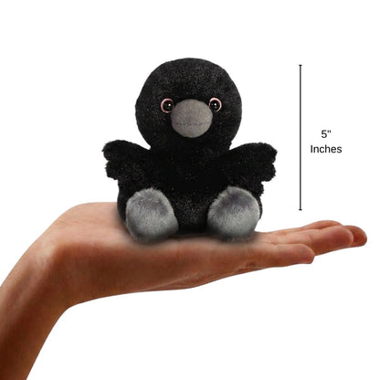 The miniature Poe Raven plush balanced in an open human hand under a 5-inch height graphic indicator.