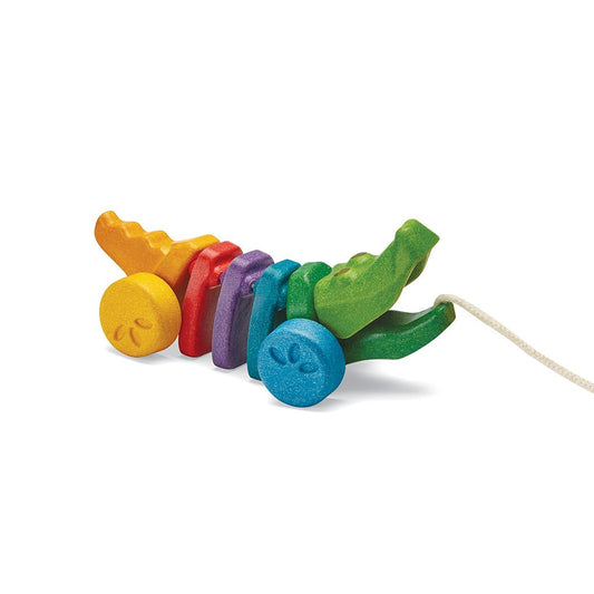 Front angle of the eco-friendly PlanToys wooden rainbow alligator pull toy with its articulated colorful body.