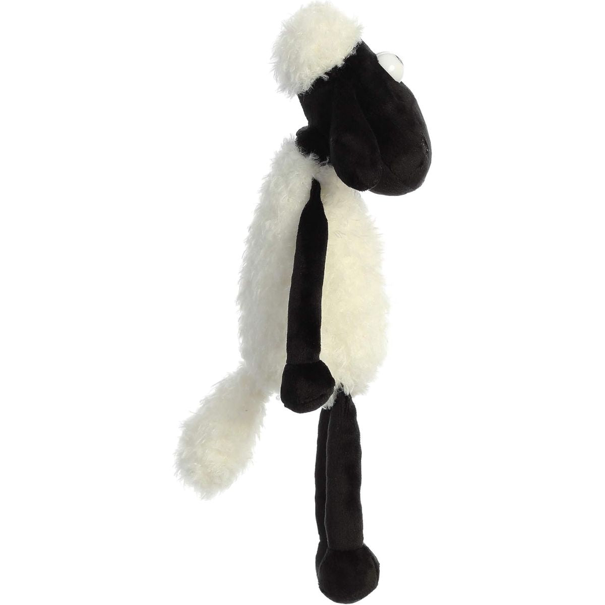 Side profile view of the Shaun the Sheep plush held upright, showing its black face and fluffy head tuft.