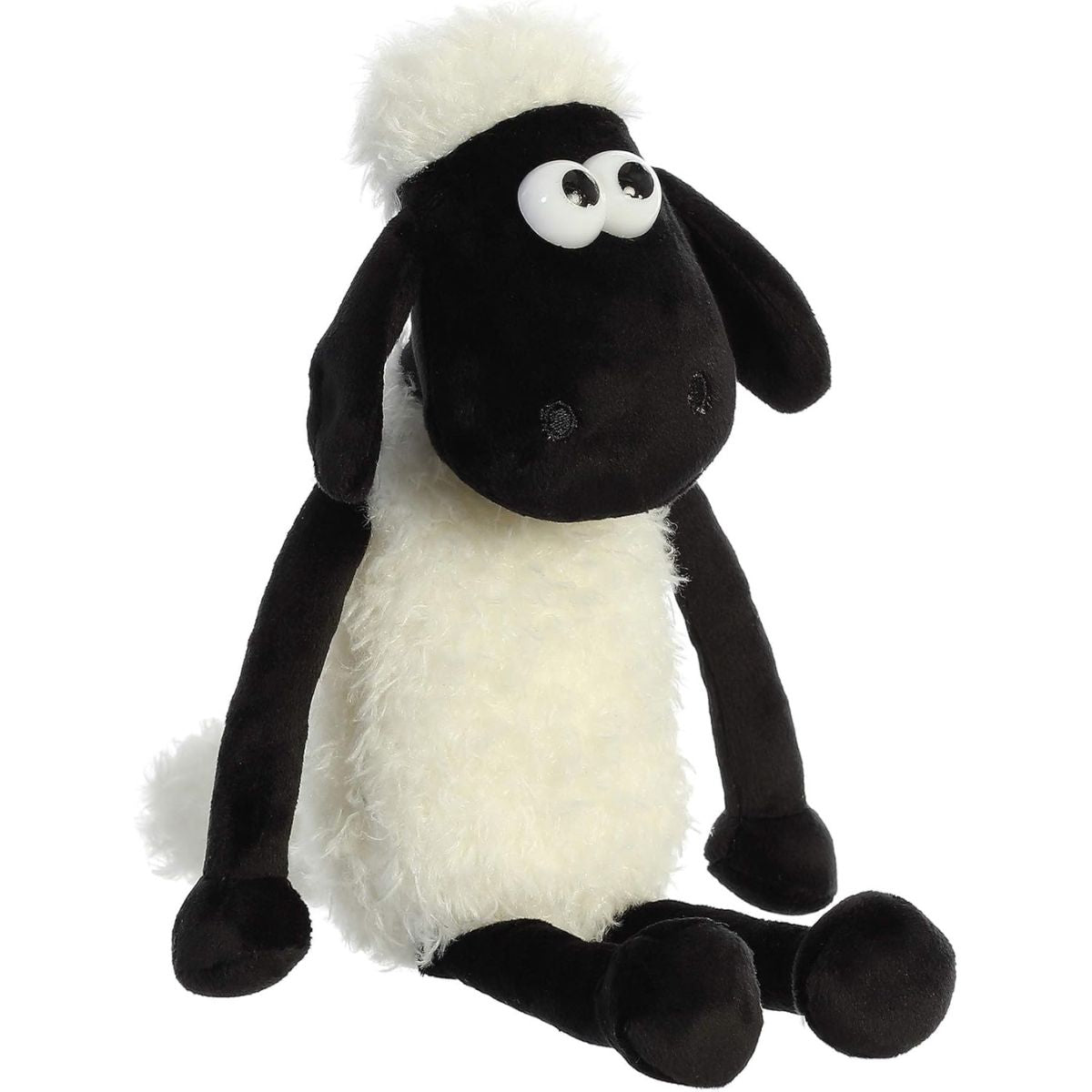 Angled front view of the 11-inch Aurora Shaun the Sheep plush sitting down, featuring fluffy white fleece and floppy black legs.
