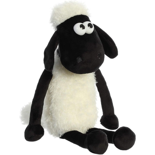 Angled front view of the 11-inch Aurora Shaun the Sheep plush sitting down, featuring fluffy white fleece and floppy black legs.