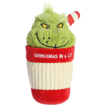 Slightly angled front view of the Grinch cup stuffed animal showing his classic grumpy smile and fluffy green hair.