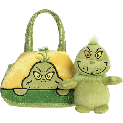 The green Grinch stuffed animal sitting right next to its empty yellow and green Fancy Pals carrying purse.