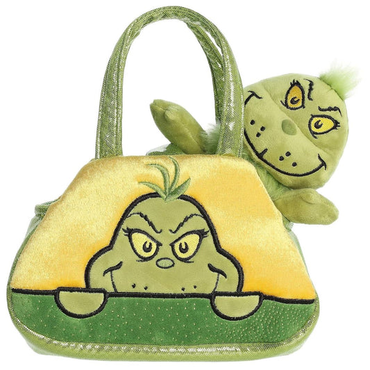 Front view of the Aurora Fancy Pals The Grinch plush sitting inside a yellow and green purse carrier featuring an embroidered peeking Grinch face.