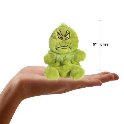 The miniature Grinch plush sitting balanced in the palm of an open human hand under a 5-inch height graphic indicator.