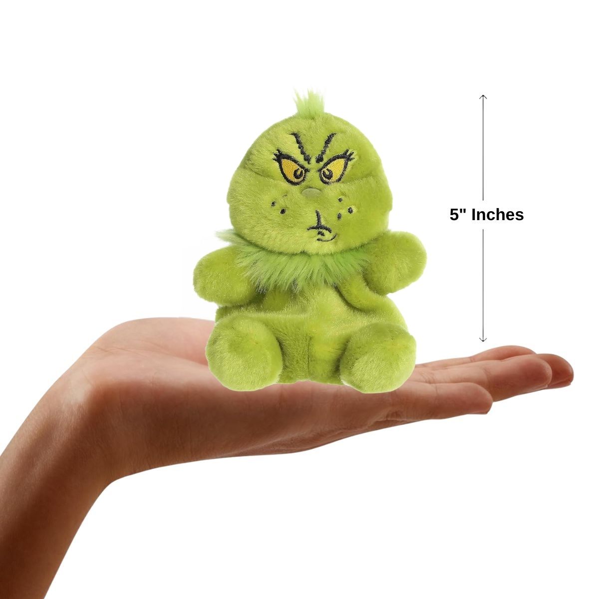 The miniature Grinch plush sitting balanced in an open human hand under a 5-inch height graphic indicator.