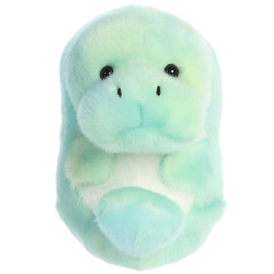 Straight front view of the round pastel green manatee plush toy highlighting its cute, gentle snout and dark eyes.