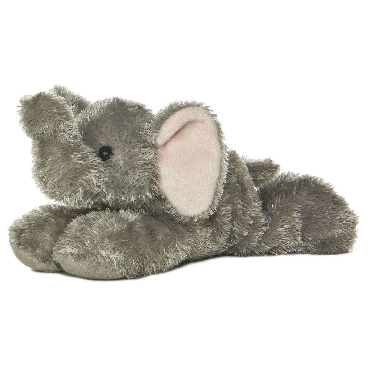 Side view of the Aurora Mini Flopsie Ellie the Elephant 8-inch plush resting on its belly, featuring soft grey fur and pink-lined ears.