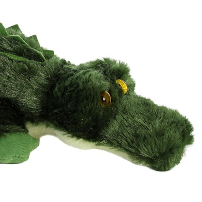 Close-up view of the alligator's face highlighting its textured green fur and striking yellow-gold eyes.