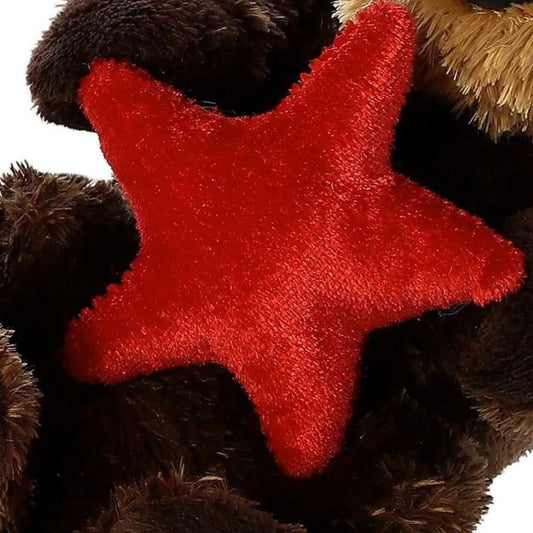 Close-up view of the plush red starfish being held by the sea otter, highlighting the soft fabric texture.