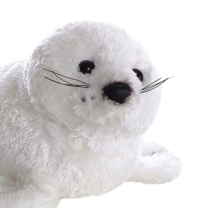 Close-up front view of the harp seal's face showing its sweet dark eyes, black nose, and realistic whiskers.